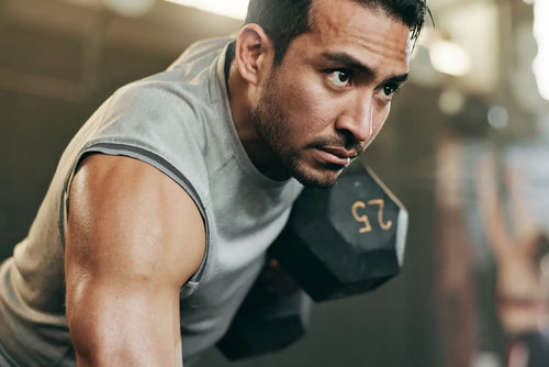 Athlete doing a dumbbell row in the gym for peak performance