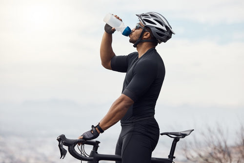 Cyclist rehydrating with a sugar-free isotonic drink